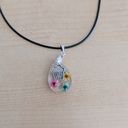 Necklace - 17.5 inches resin teardrop with flowers and silver cupcake charm on black leather cord with clasp