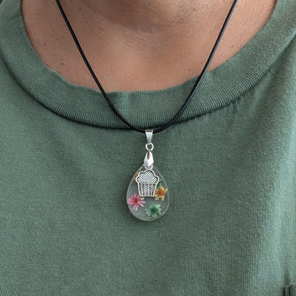 Necklace - 17.5 inches resin teardrop with flowers and silver cupcake charm on black leather cord with clasp