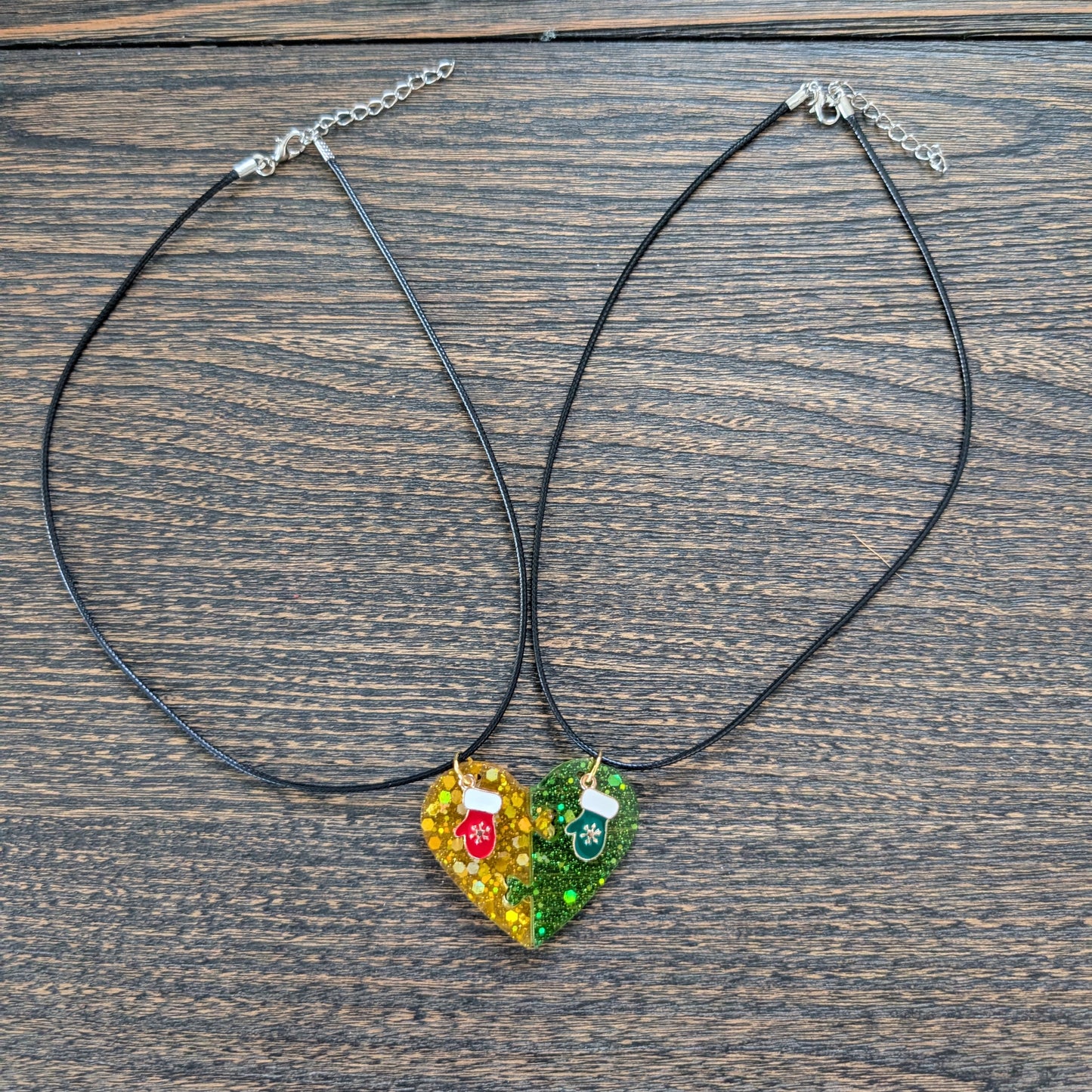 Necklace - 17.5 inches black waxed cord with two resin half hearts and a Christmas charm
