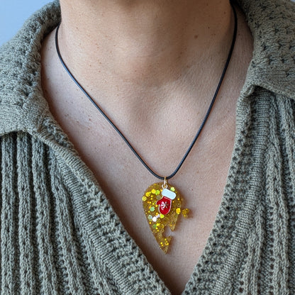 Necklace - 17.5 inches black waxed cord with two resin half hearts and a Christmas charm