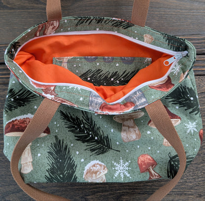 Snowy Mushrooms bag with orange lining one inner pocket and zipper closure