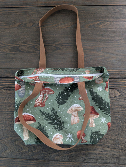 Snowy Mushrooms bag with orange lining one inner pocket and zipper closure