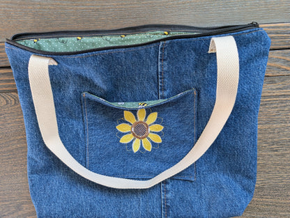 Jean tote bag with bees on green dots lining one outer pocket one inner pocket and zipper closure