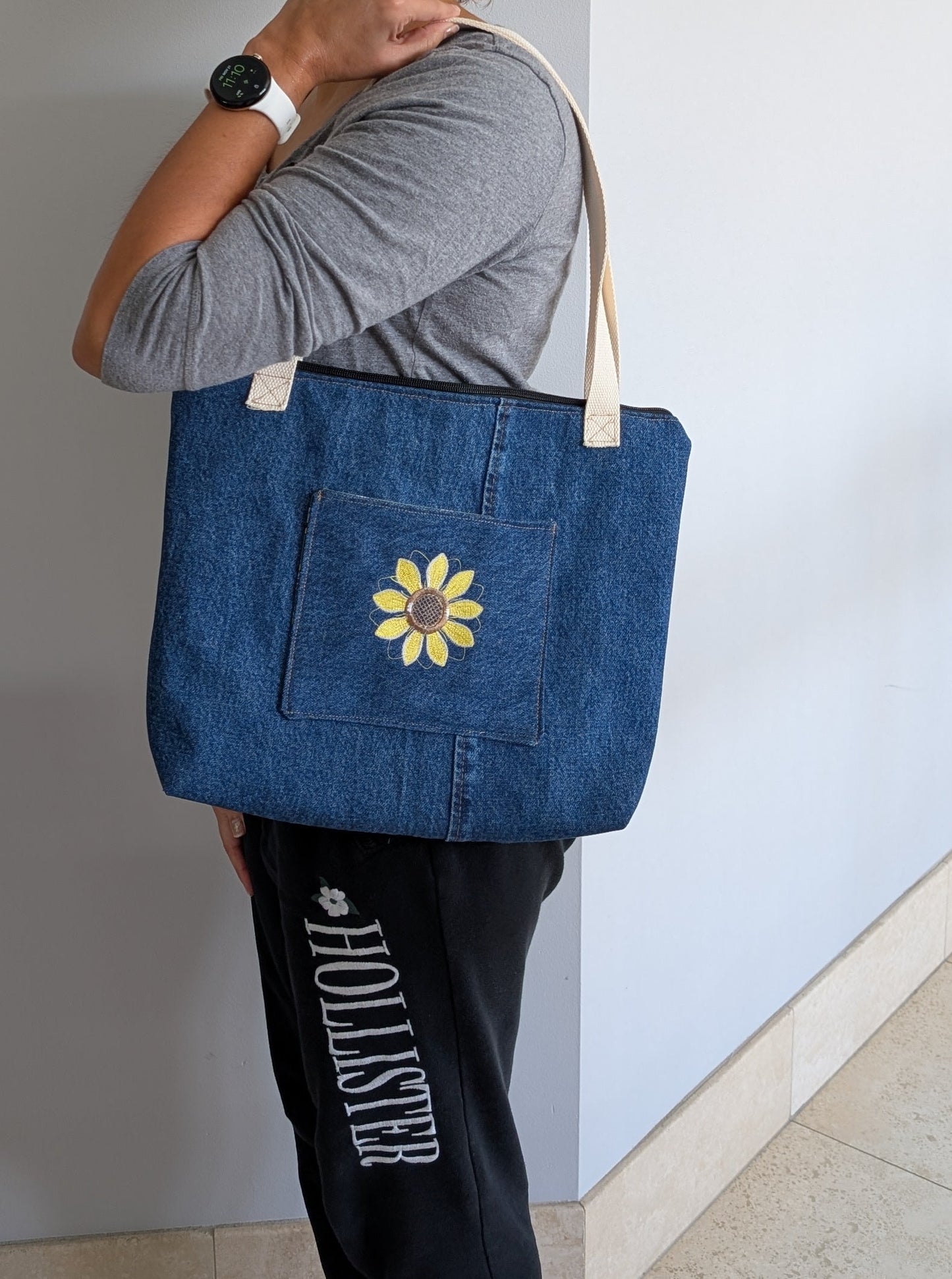 Jean tote bag with bees on green dots lining one outer pocket one inner pocket and zipper closure