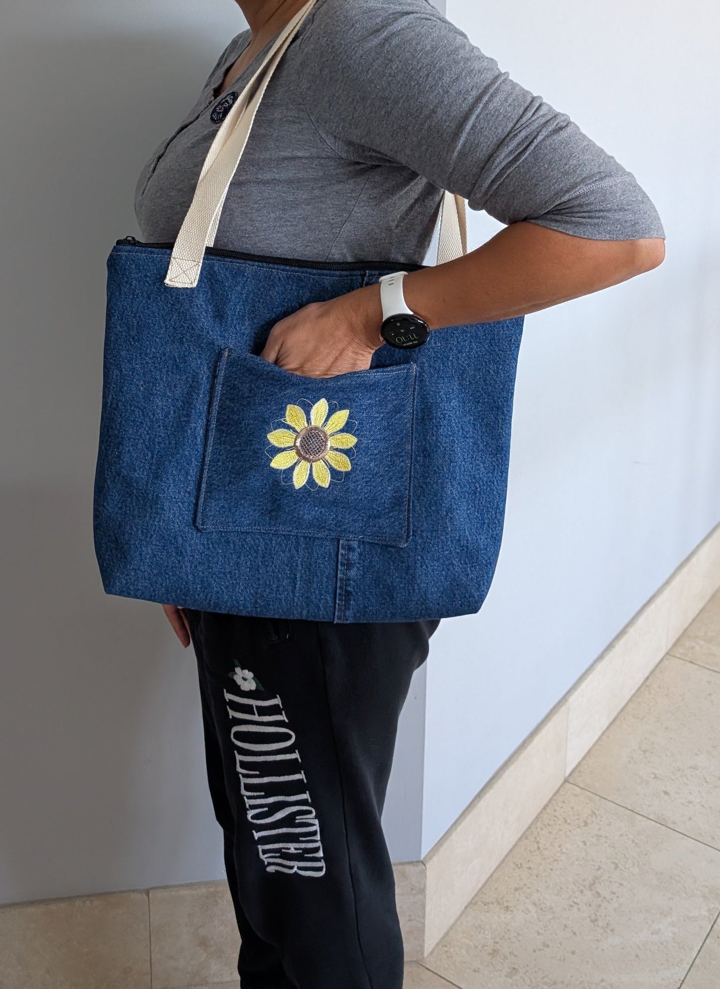 Jean tote bag with bees on green dots lining one outer pocket one inner pocket and zipper closure