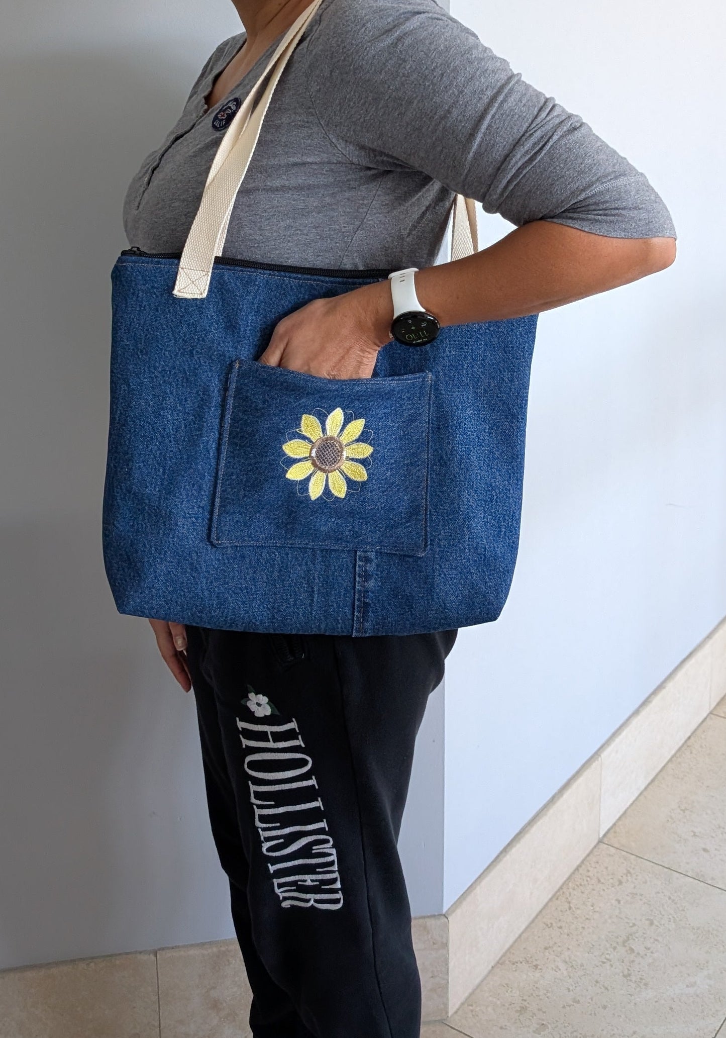 Jean tote bag with bees on green dots lining one outer pocket one inner pocket and zipper closure