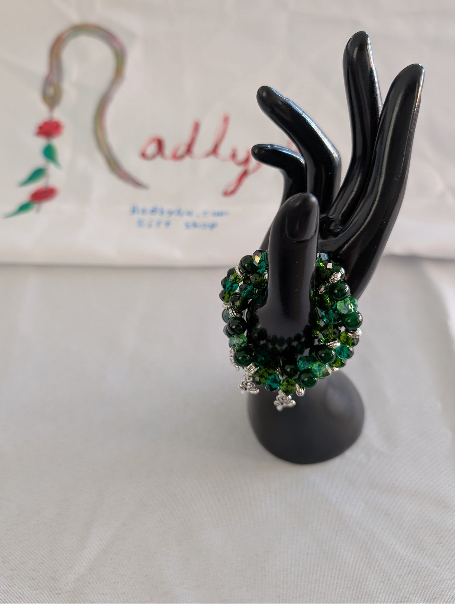 Bracelet - Elastic green beads with silver flower charm