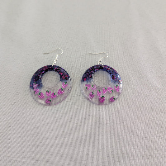 Hoop earrings with grapes design on a gray background