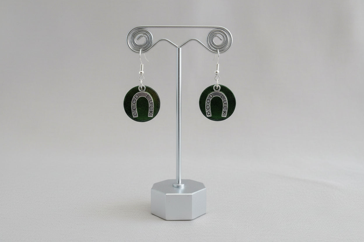 Horseshoe-shaped earrings on a gray background
