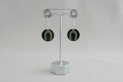 Horseshoe-shaped earrings on a gray background