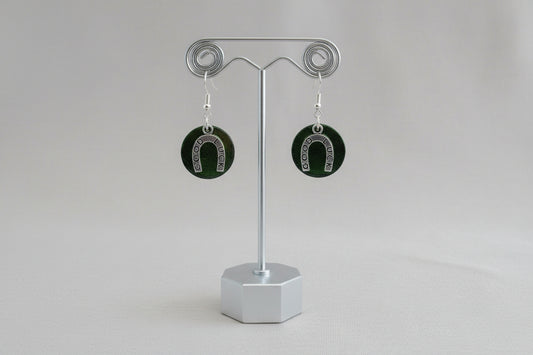 Horseshoe-shaped earrings on a gray background