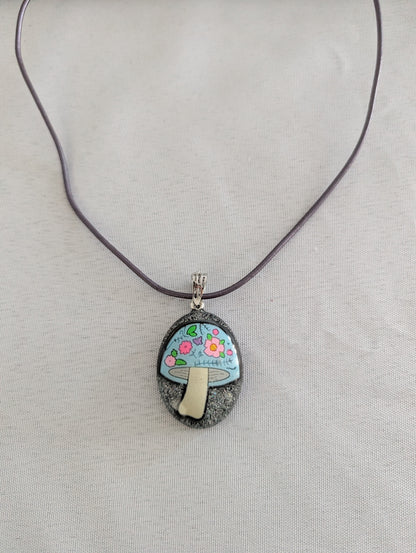 Necklace with a pendant featuring a mushroom floral design on a plain background