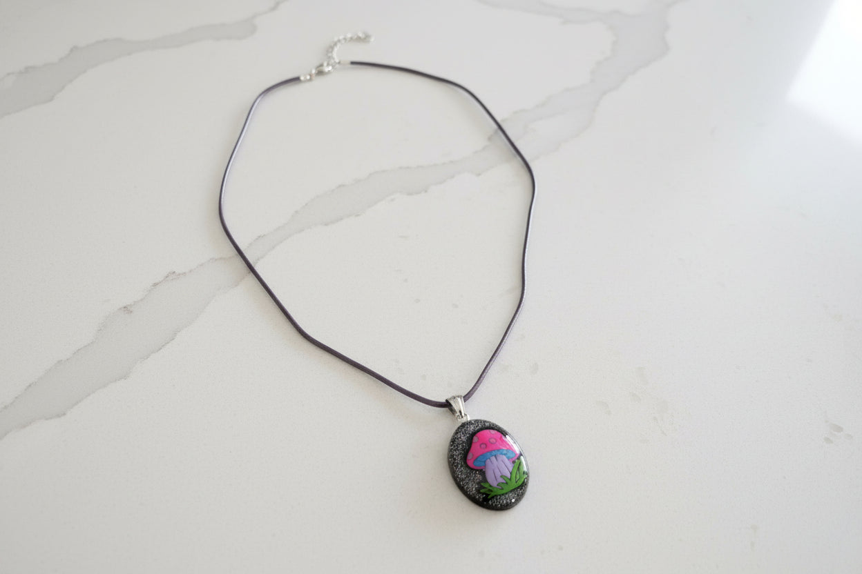 Necklace with a pendant featuring a mushroom design on a light gray background