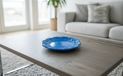 Blue decorative plate on a wooden coffee table in a living room.