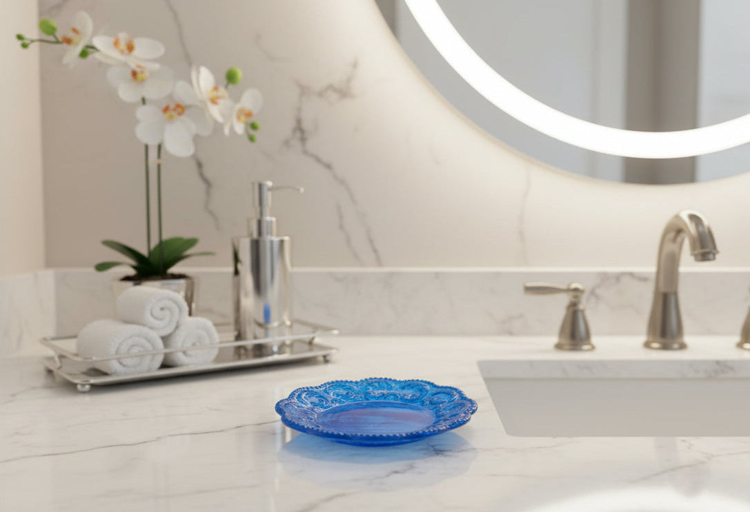 Bathroom counter with blue decorative plate, towels, and a plant.