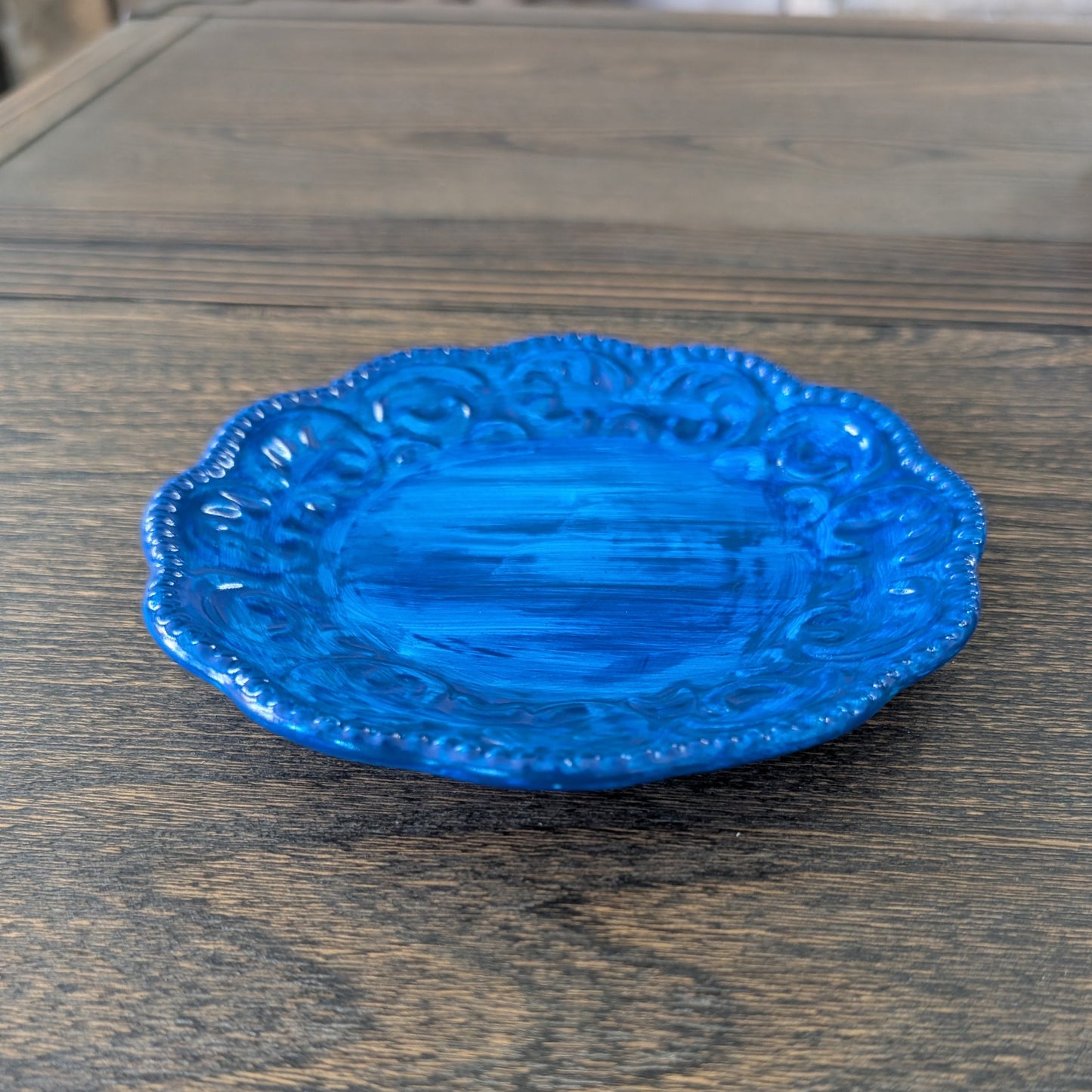 Blue decorative plate on a wooden surface