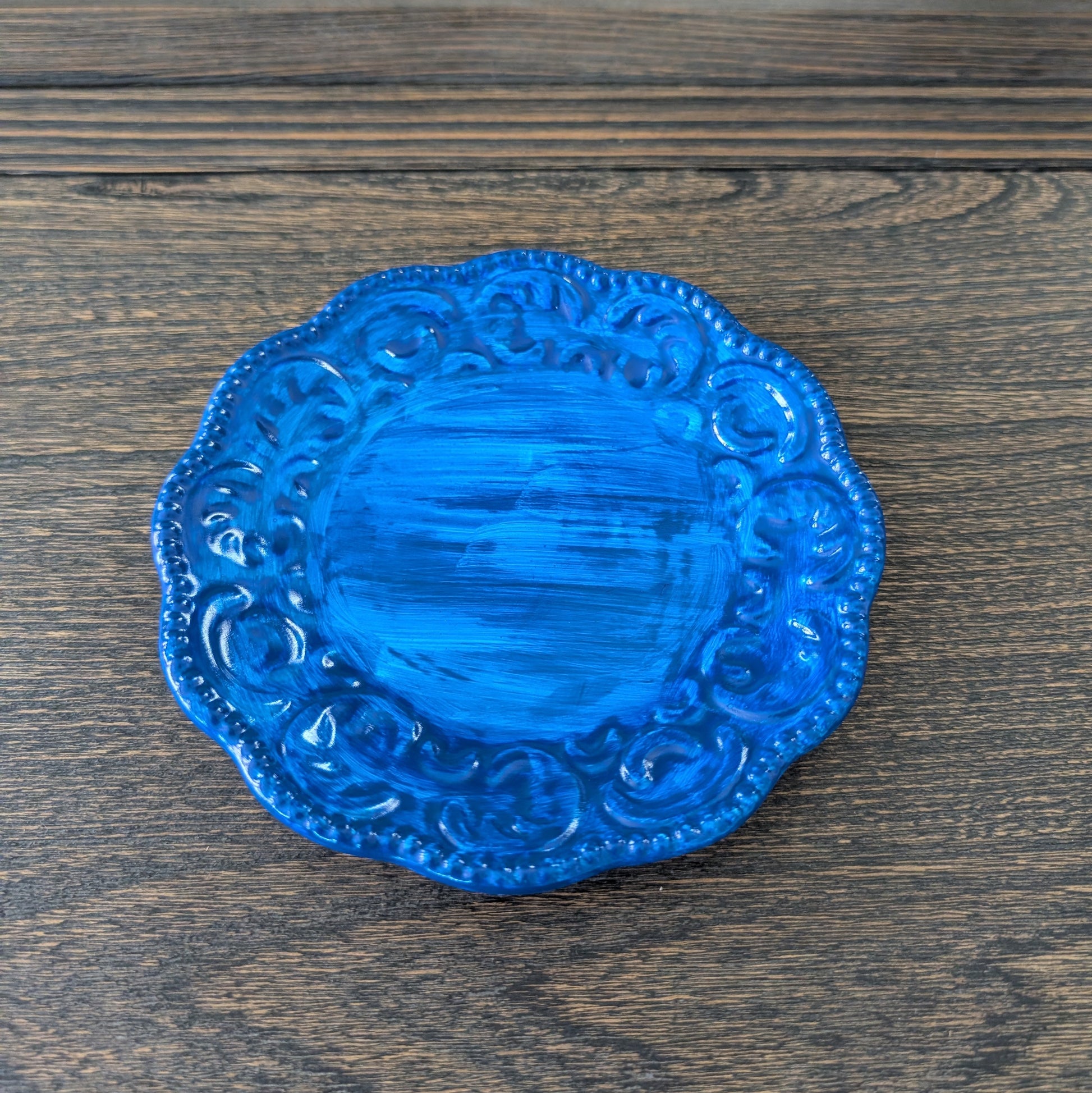 Blue decorative plate on a wooden surface