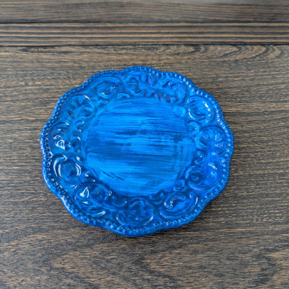 Blue decorative plate on a wooden surface