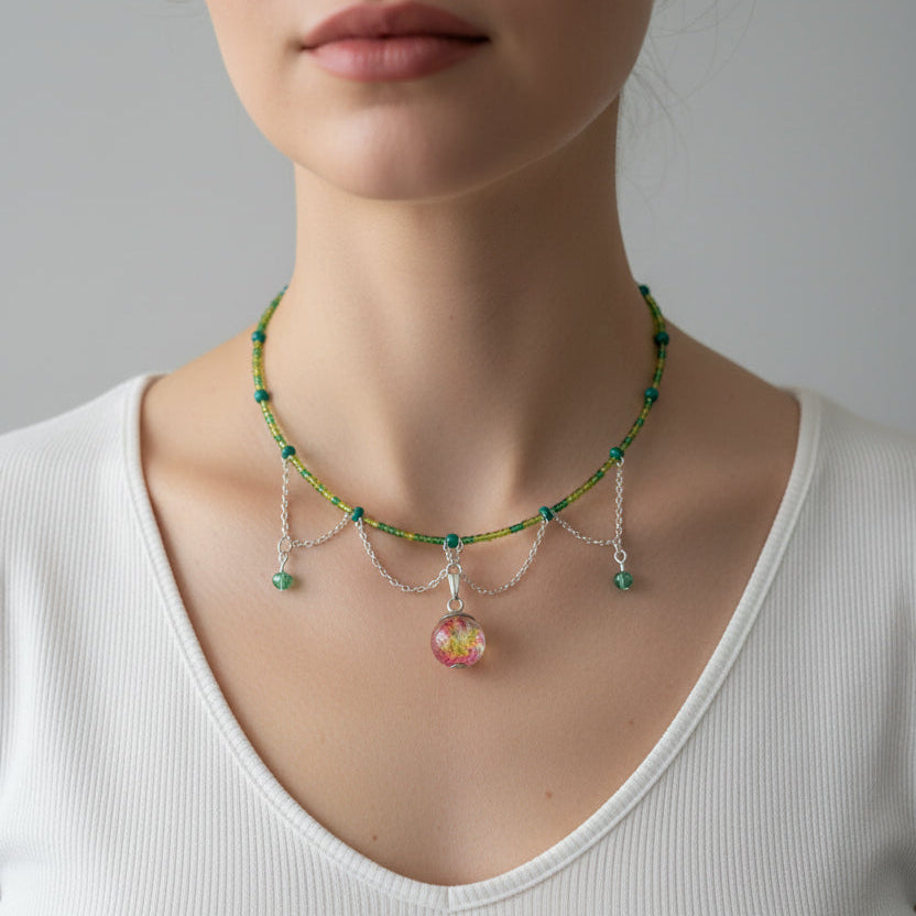 Close-up of a woman wearing a delicate necklace with colorful beads against a neutral background