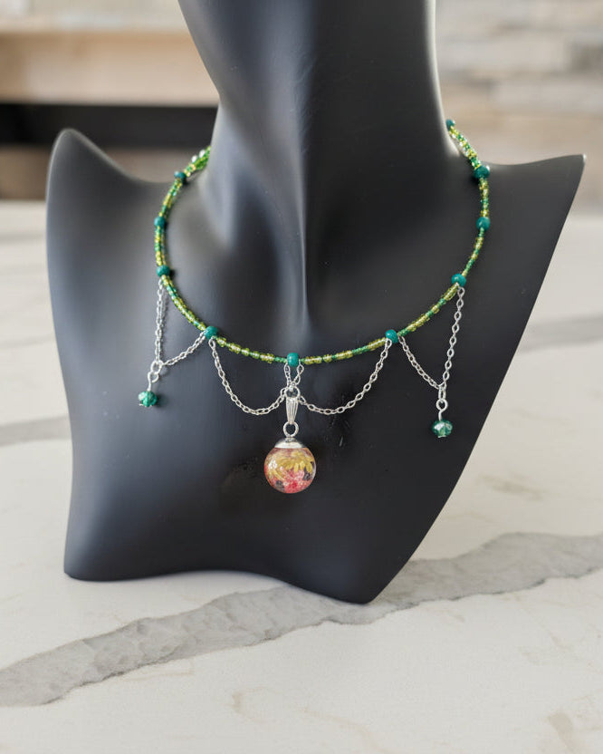 Necklace with a colorful pendant on a mannequin bust