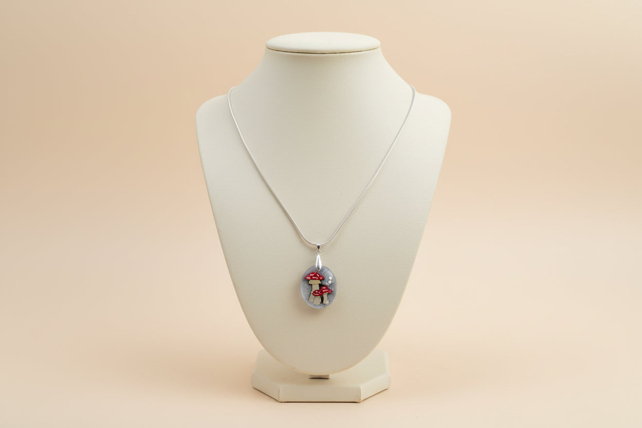 Necklace with a mushroom pendant on a jewelry holder