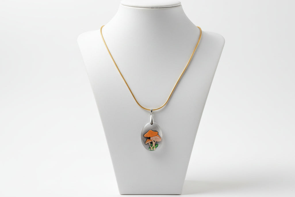Necklace with a pendant on a mannequin bust against a white background