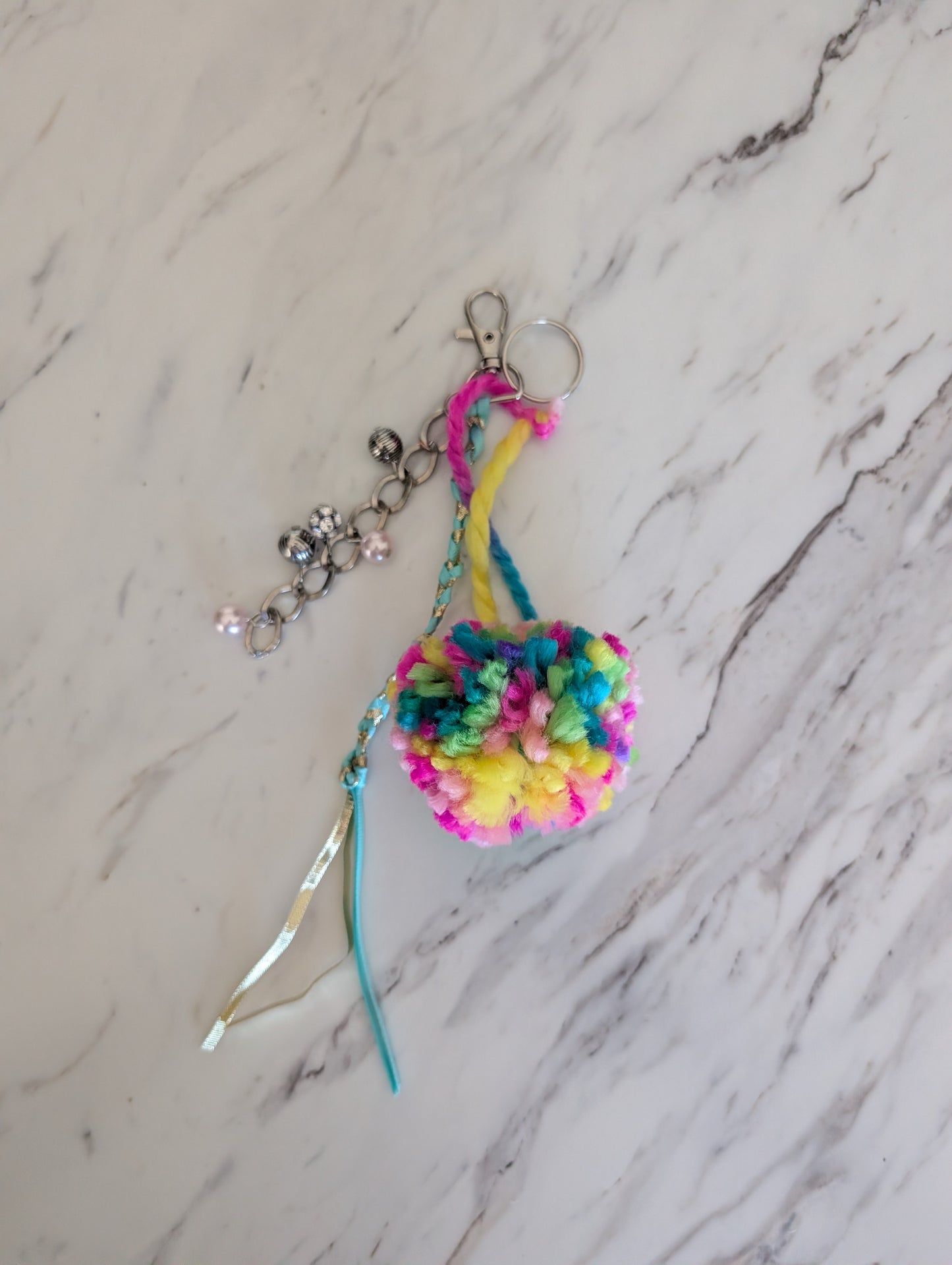 Colorful yarn pompom keychain with beaded chain and ribbon