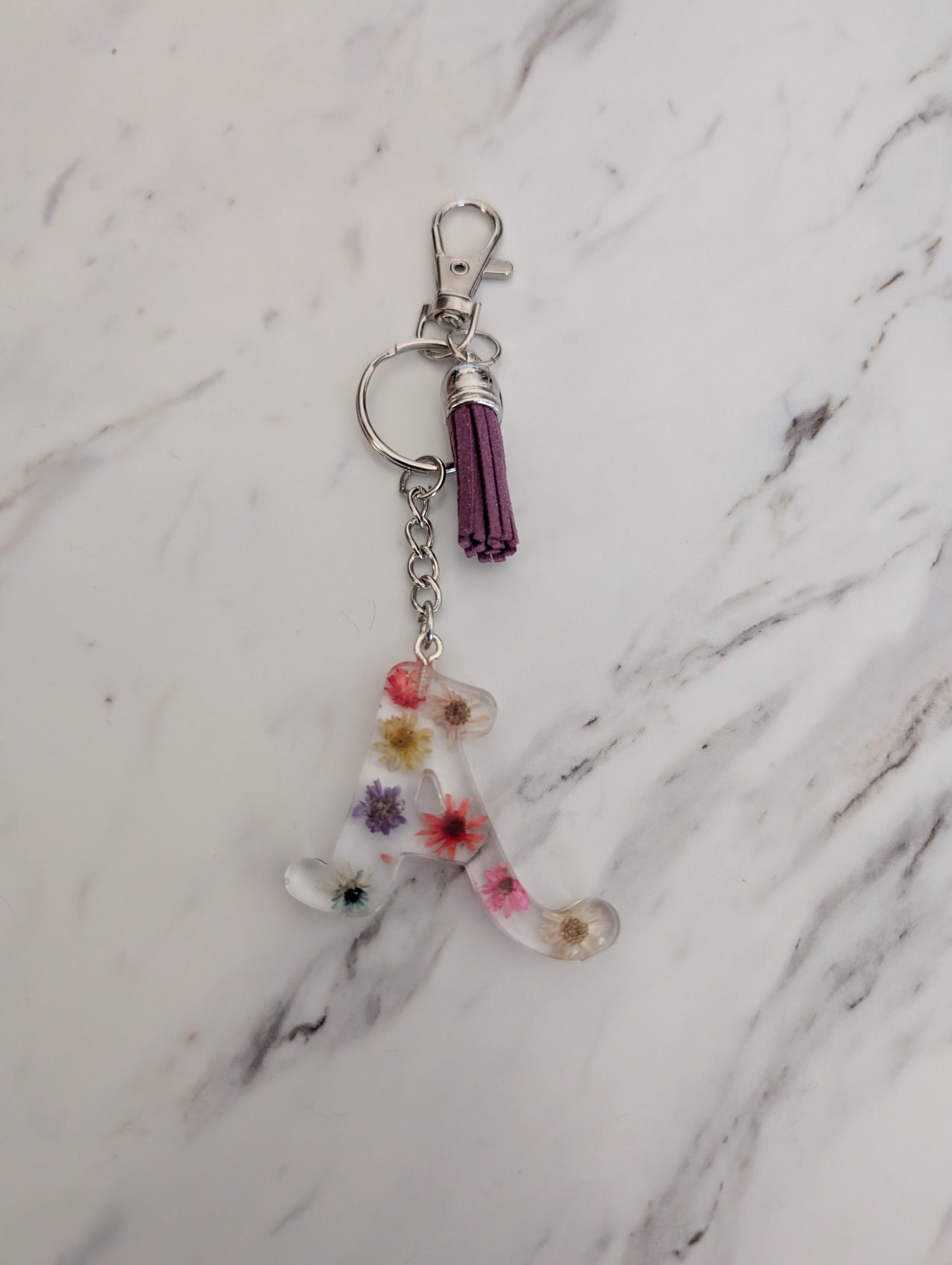Keychain with floral design on a marble surface