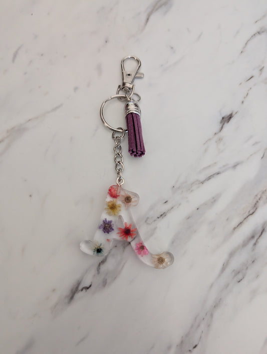 Keychain with floral design on a marble surface
