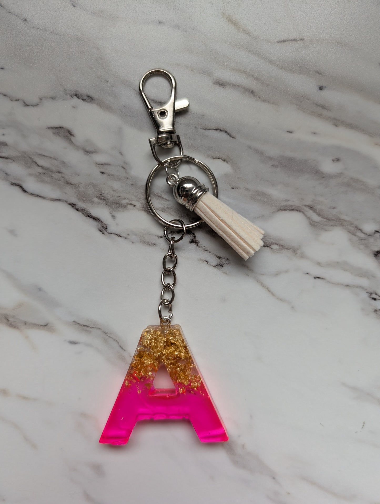 Keychain with letter 'A' charm on a marble background
