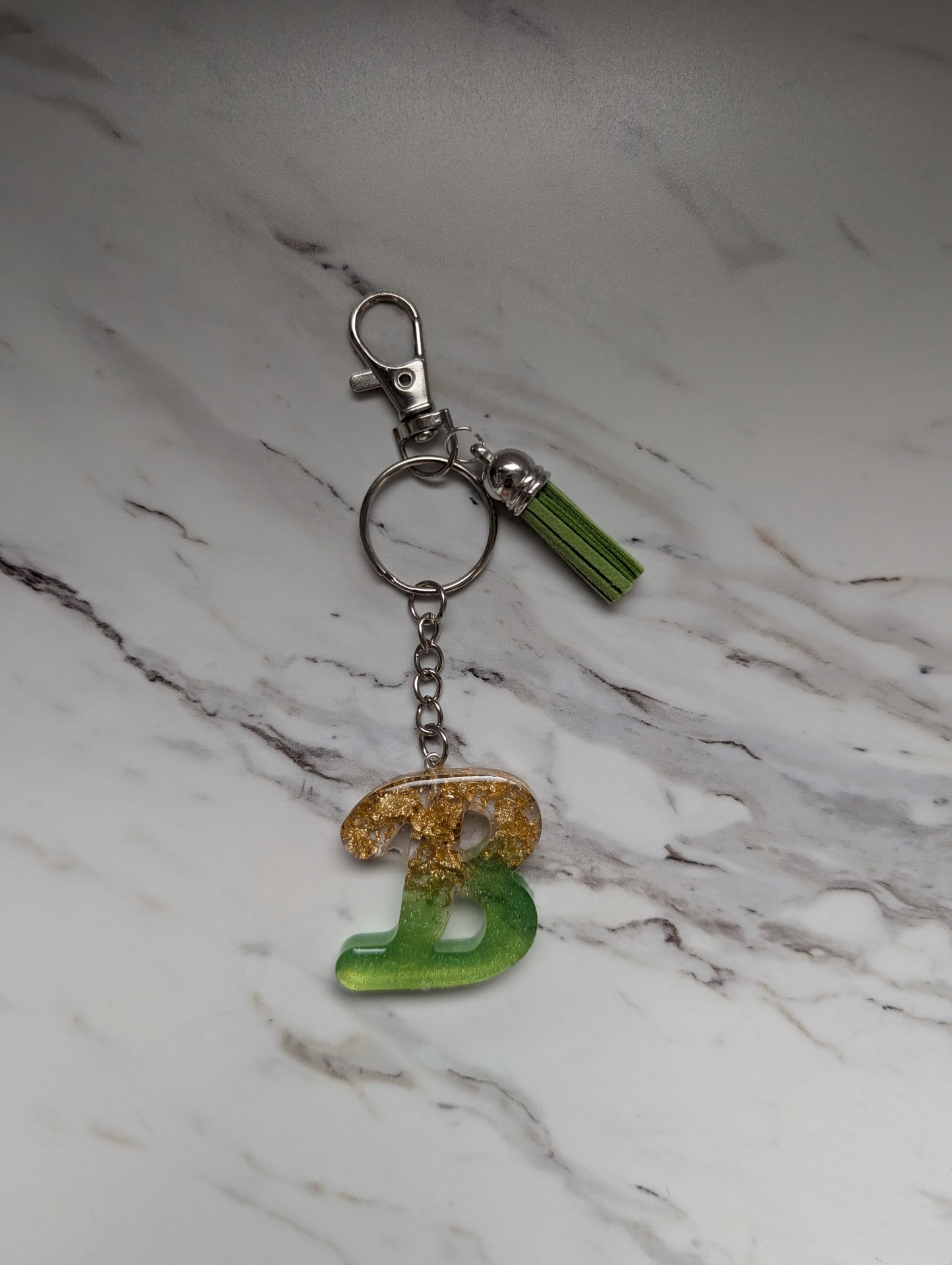Keychain with a letter 'B' on a marble surface