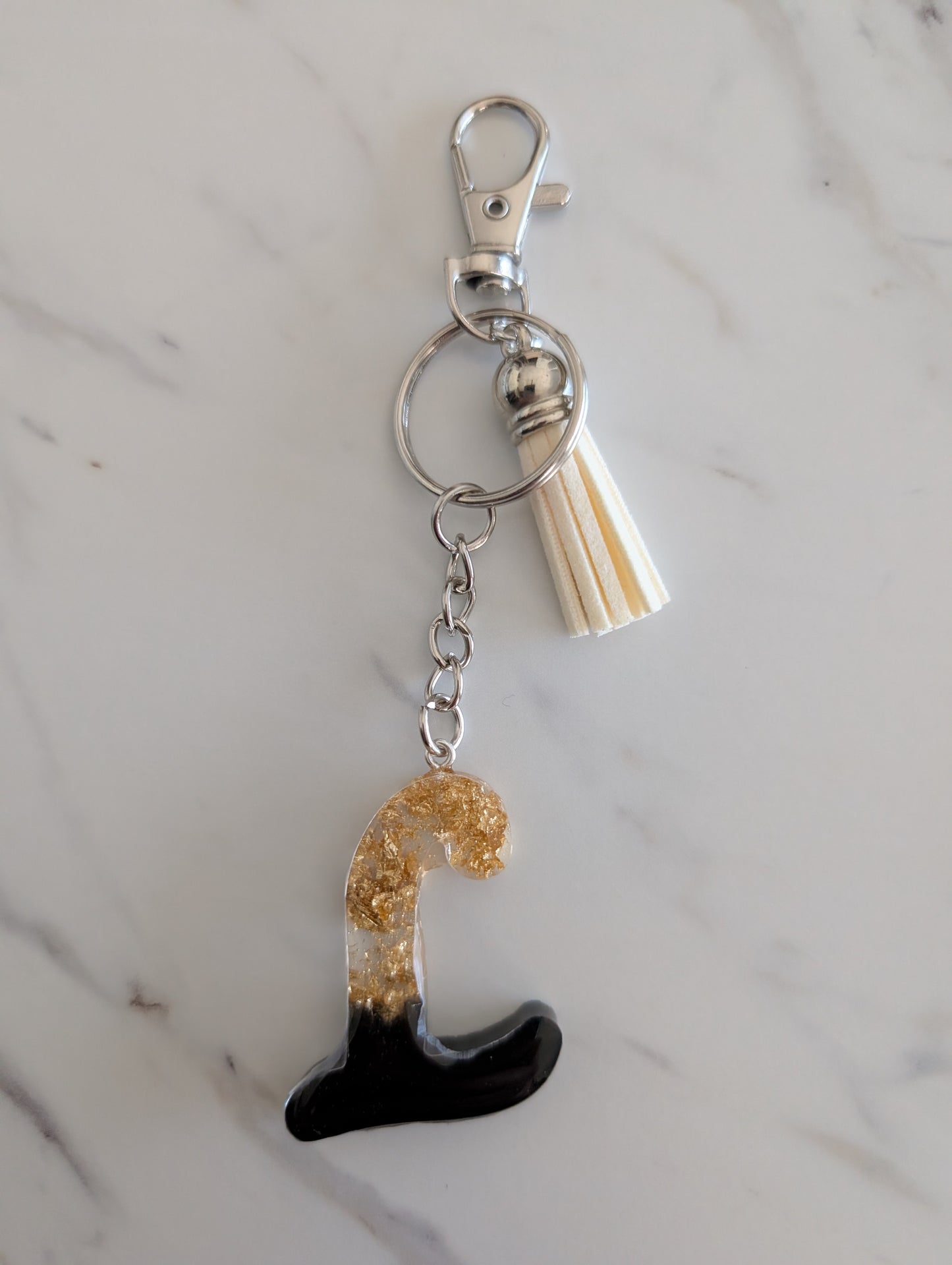 Keychain with a gold and black letter L charm