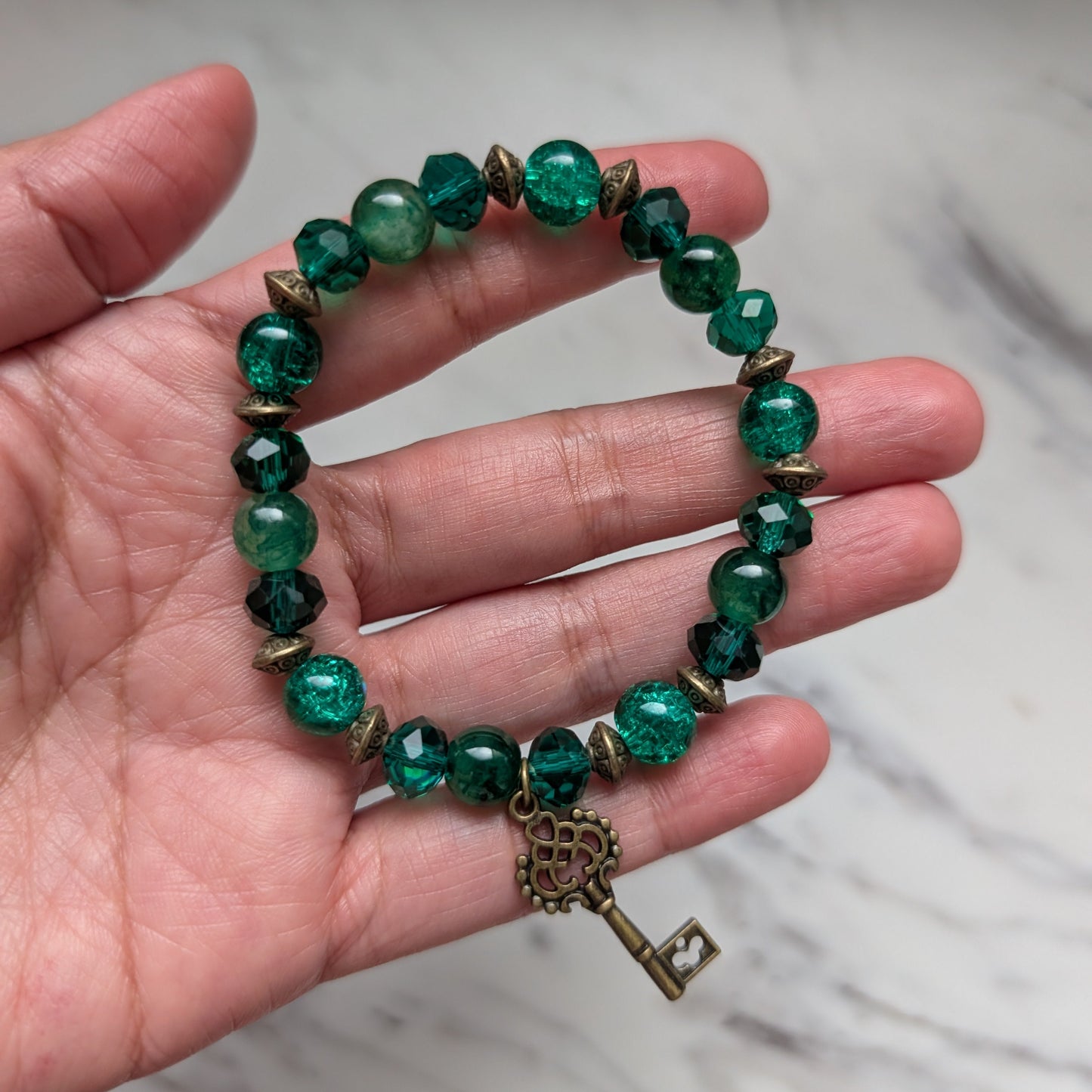 Emerald Green Crystal & Glass Beaded Elastic Bracelet with Bronze Key Charm