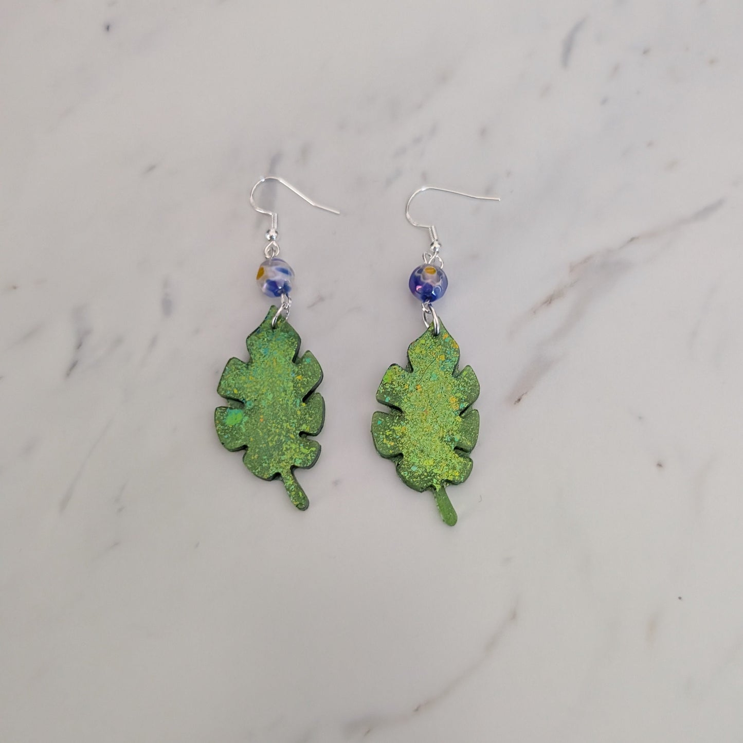 Sparkling Botanical Leaf Dangle Earrings with Blue Floral Accent