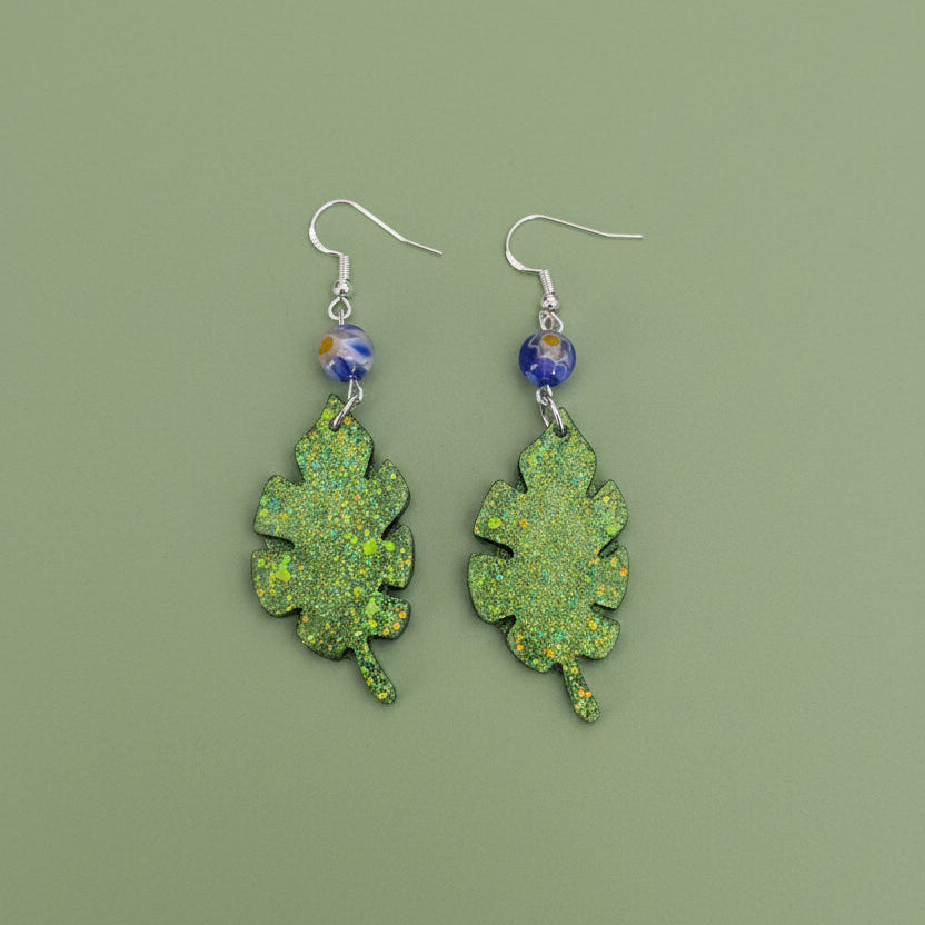 Sparkling Botanical Leaf Dangle Earrings with Blue Floral Accent