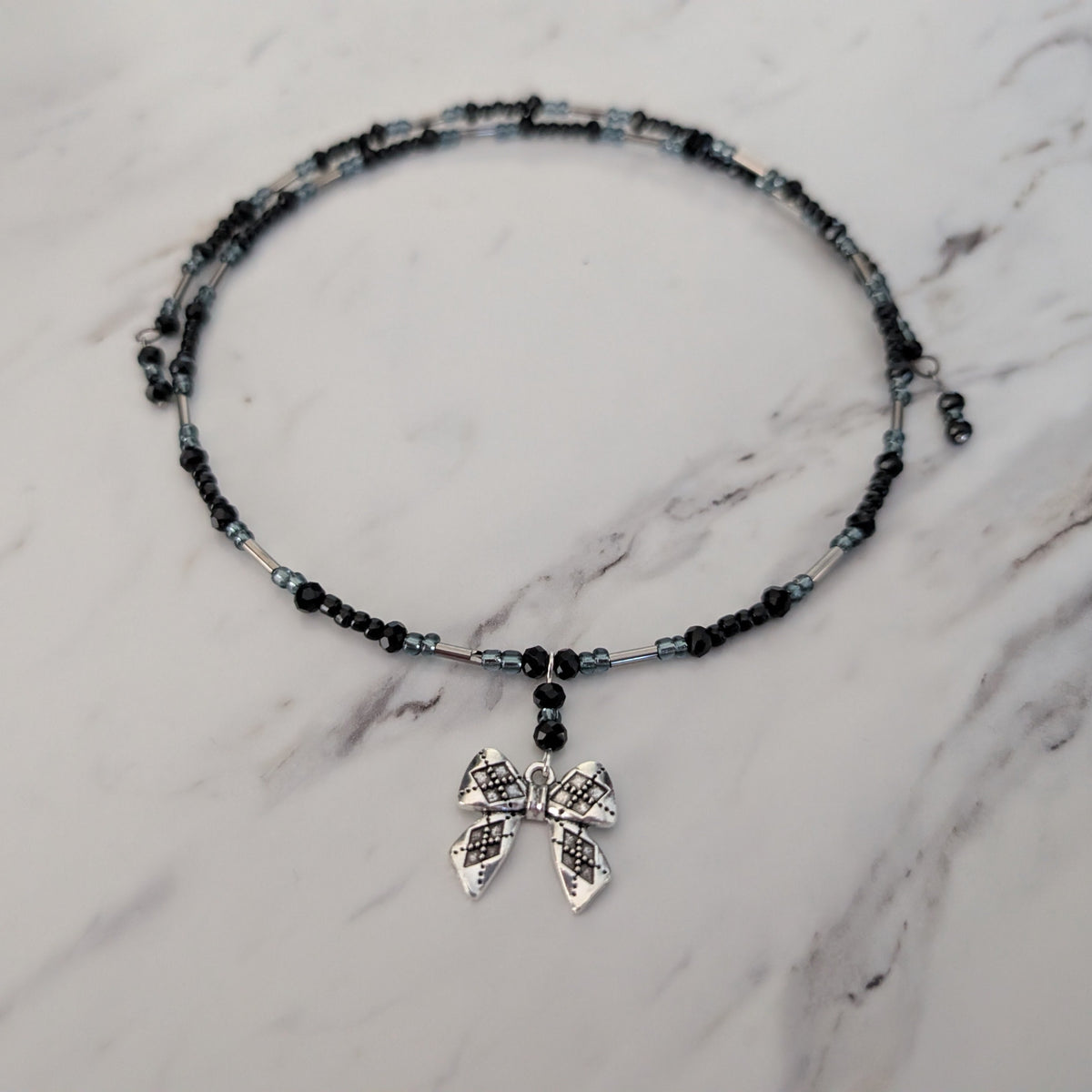 Black Crystal & Silver Tube Bead Memory Wire Choker – Textured Bow Charm