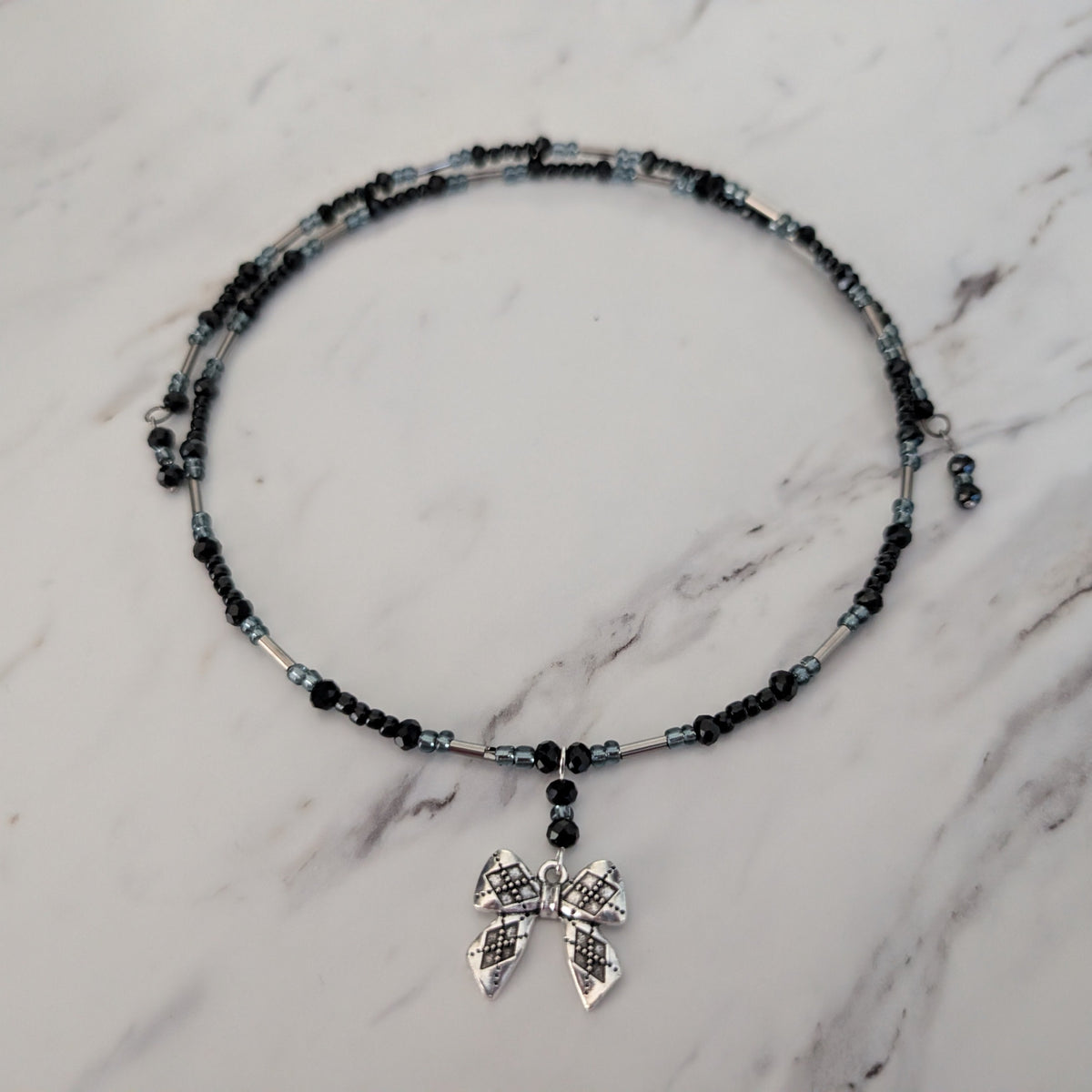 Black Crystal & Silver Tube Bead Memory Wire Choker – Textured Bow Charm
