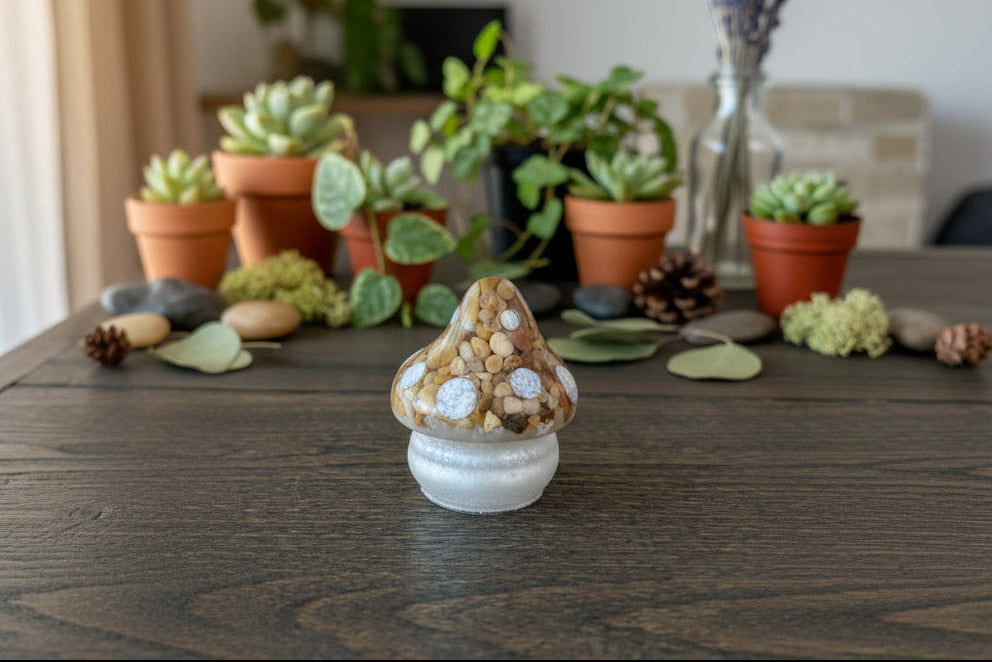 Decorative mushroom on a wooden table with potted plants in the background