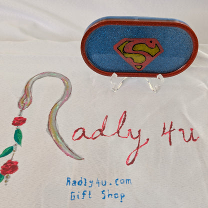 This Knickknack trinket dish not only adds a fun touch to any space with its super hero theme, but also serves as a functional and stylish storage option for small items. Made of durable resin, it is designed to keep jewelry, change, and other trinkets organized and easily accessible.