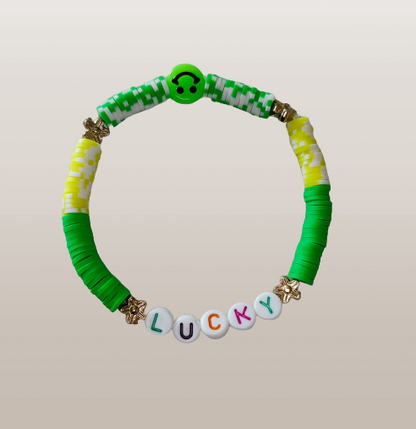 Bracelet - Medium 7.5 inches "Lucky" elastic green & yellow clay beads with gold flower spacer beads and a green happy face bead