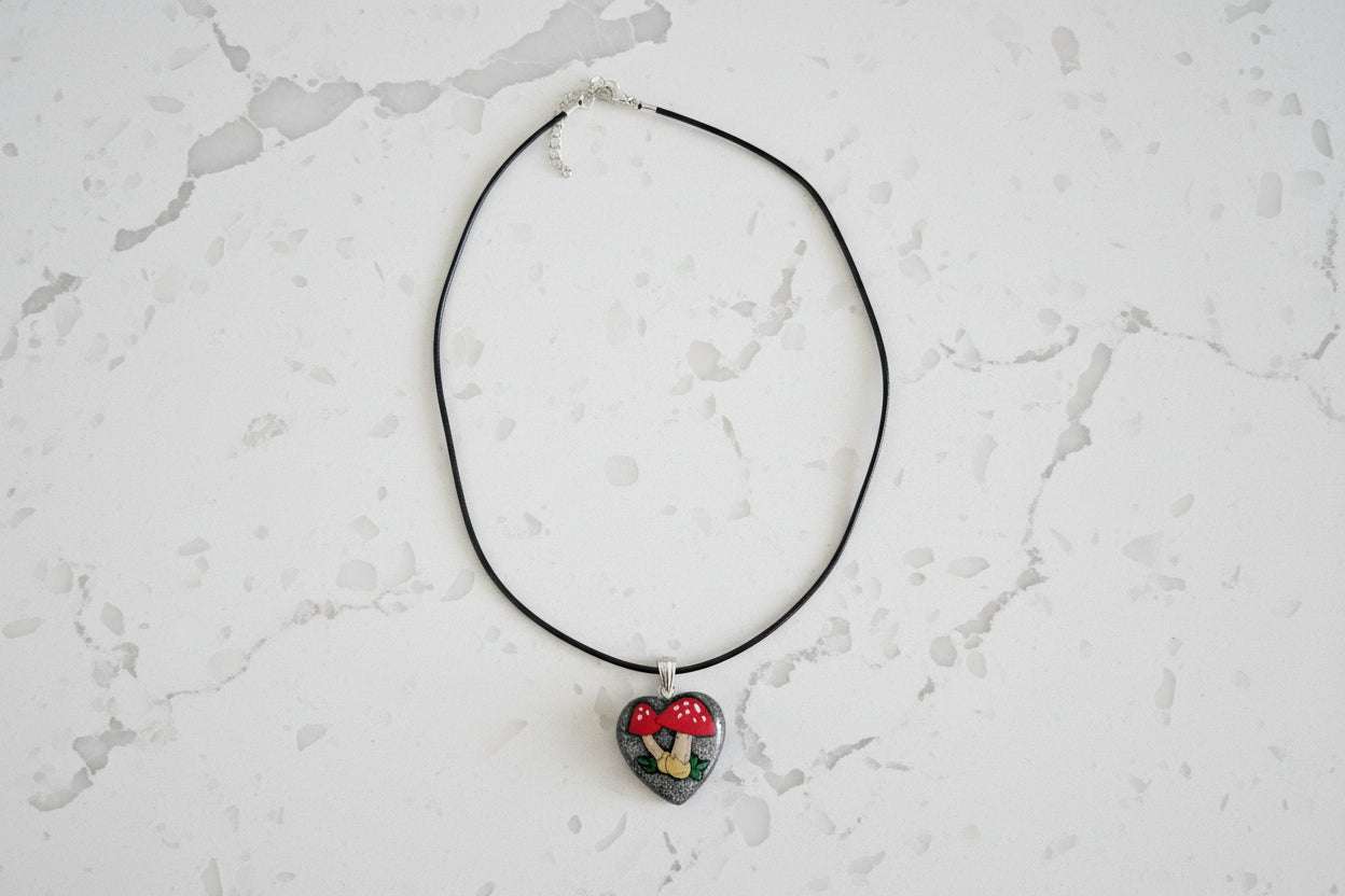 Necklace with a heart-shaped pendant on a light gray textured background