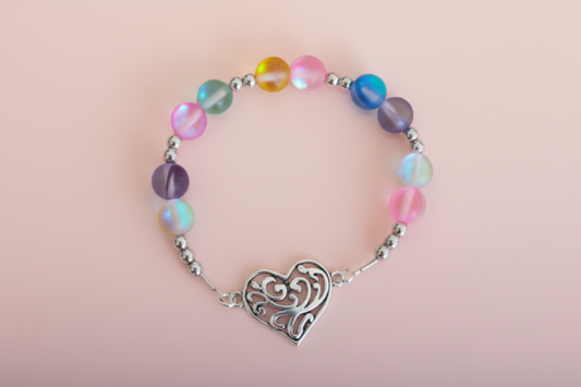 A multicolored elastic bracelet with colorful glass beads and a silver heart charm.