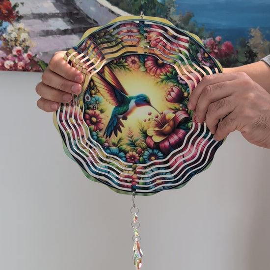 Metal hummingbird wind spinner for garden decor, outdoor hanging kinetic yard art.