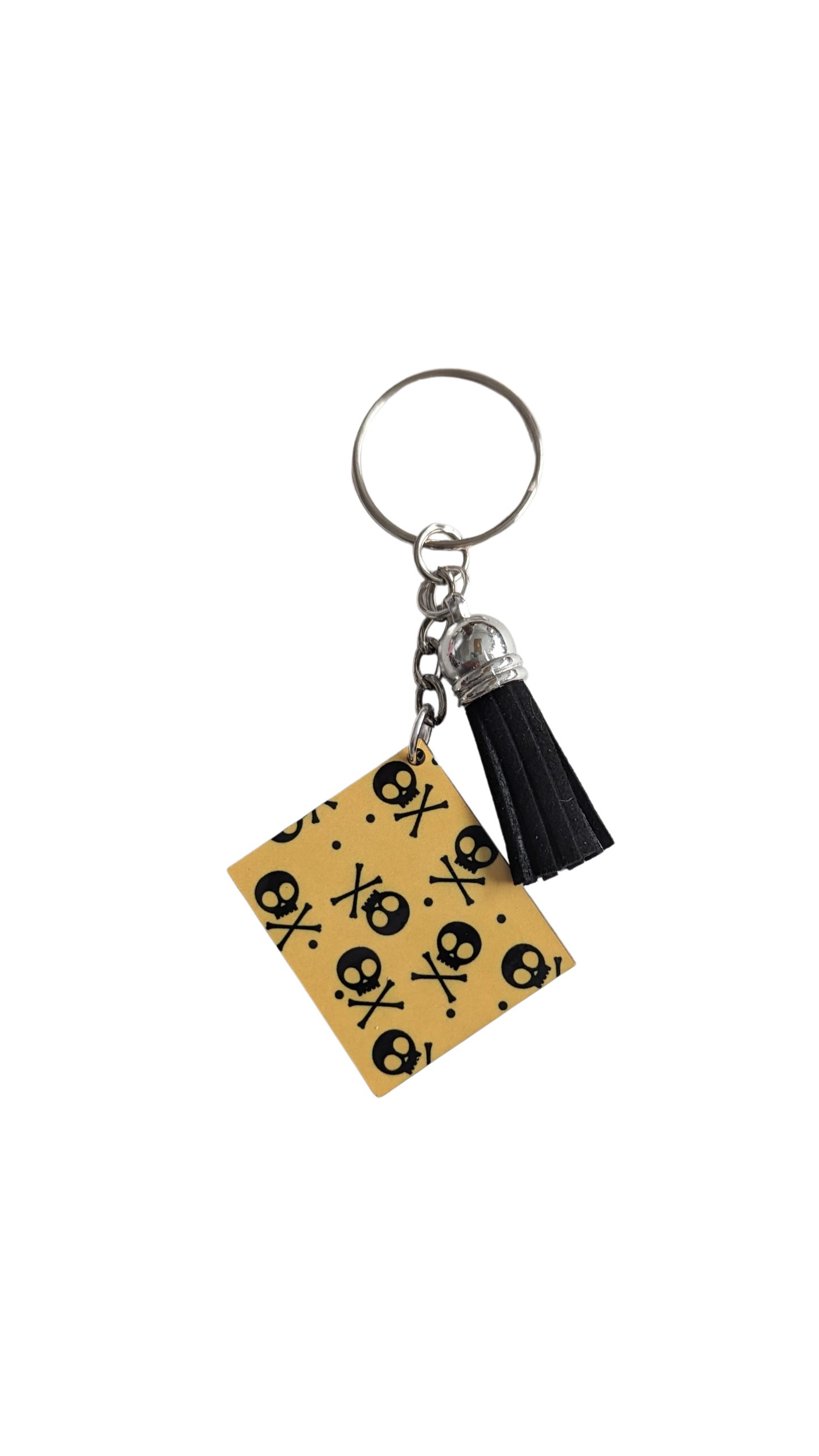 Keychain - Double sided sublimated black skulls on yellow background image with black acrylic tassel