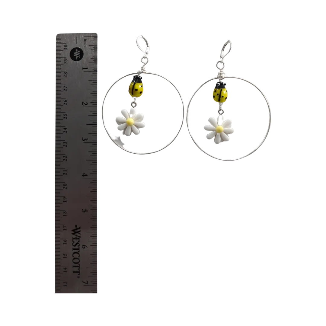 Earrings - Glass lady bug with Paris daisy flower and wire circle on lever back hoop earring