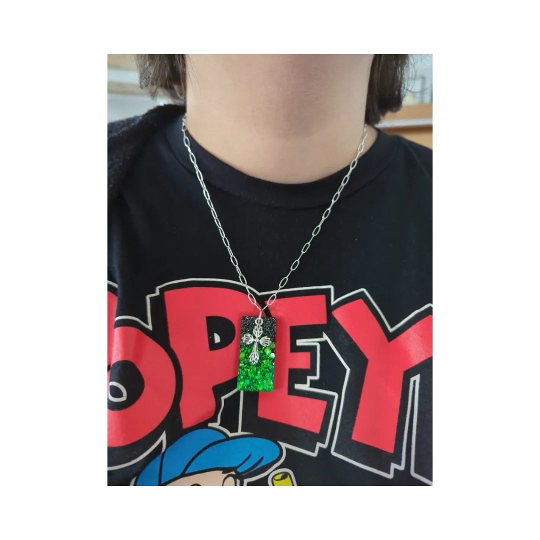 Necklace - 18.5 inches black green glitter resin rectangle with silver cross charm on silver paperclip cable chain