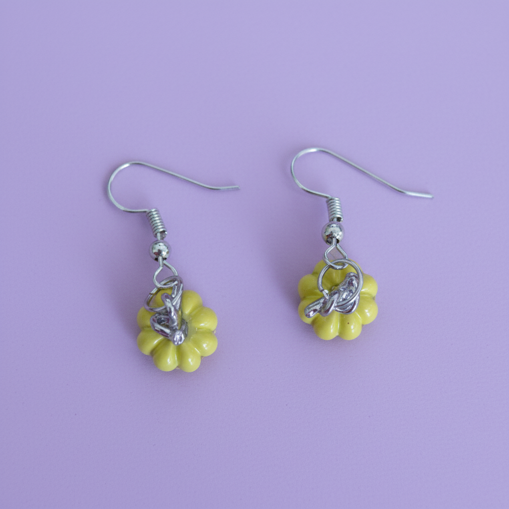 A pair of yellow pumpkin-shaped earrings with hooks