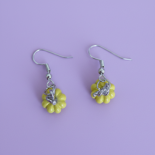 A pair of yellow pumpkin-shaped earrings with hooks