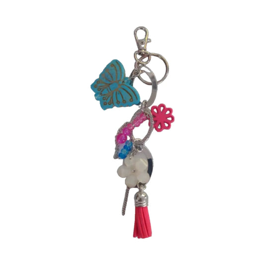 A bag charm featuring a butterfly flower charm, beads, chains, and a tassel in multicolor.
